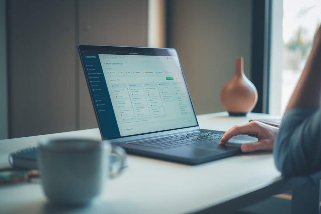 Professional using a laptop in a modern digital business workspace