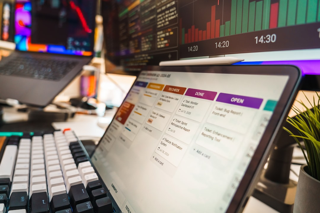 Modern digital business workspace with software dashboard and analytics screens